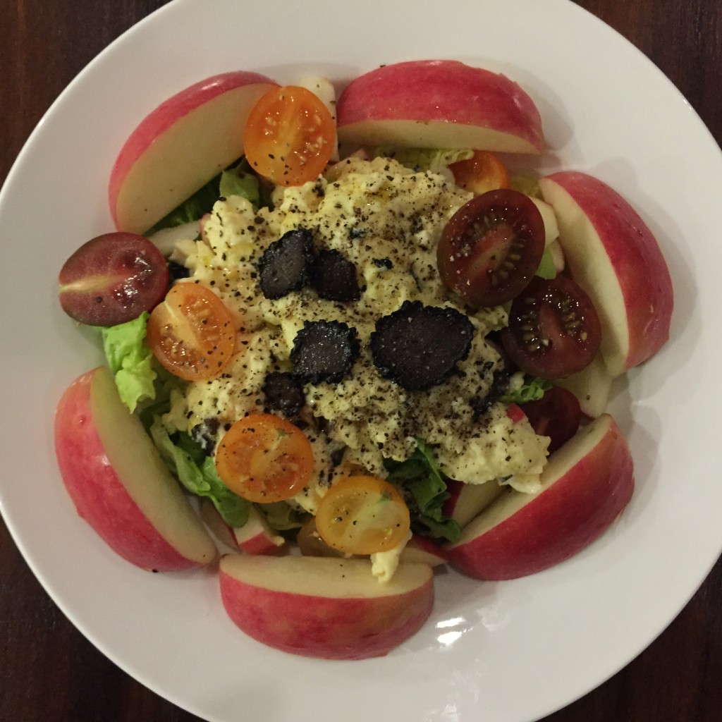 Salad and scramble eggs with summer black truffles